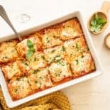 Spinach lasagna rolls out of the oven and cut into individual servings.