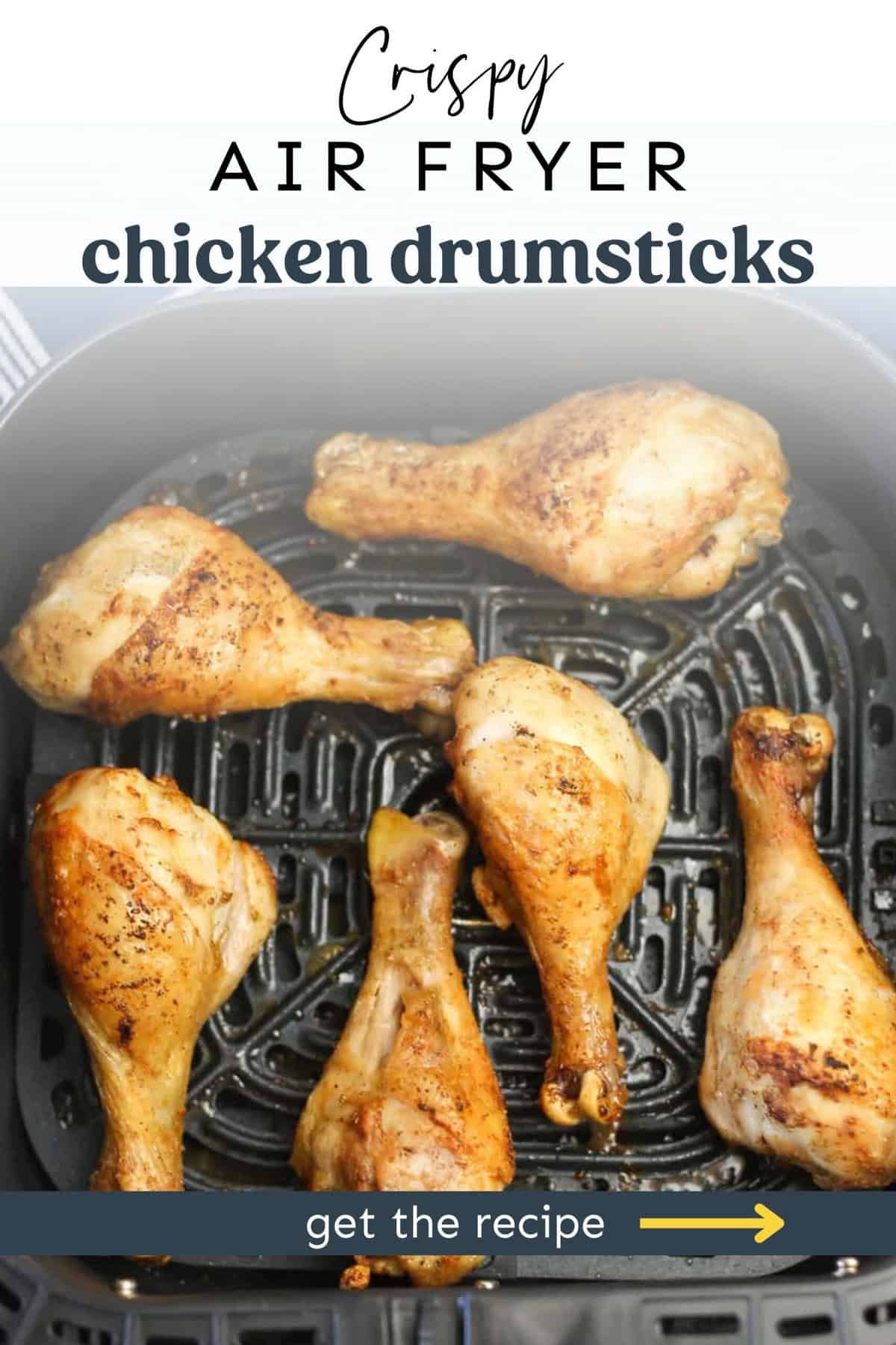 Chicken drumsticks in an air fryer basket.