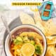 Bowl of Mexican soup with chips.