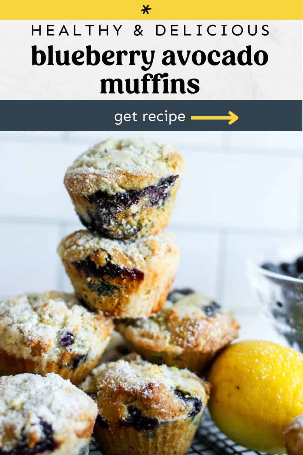 Blueberry avocado muffins stacked up on a baking rack.