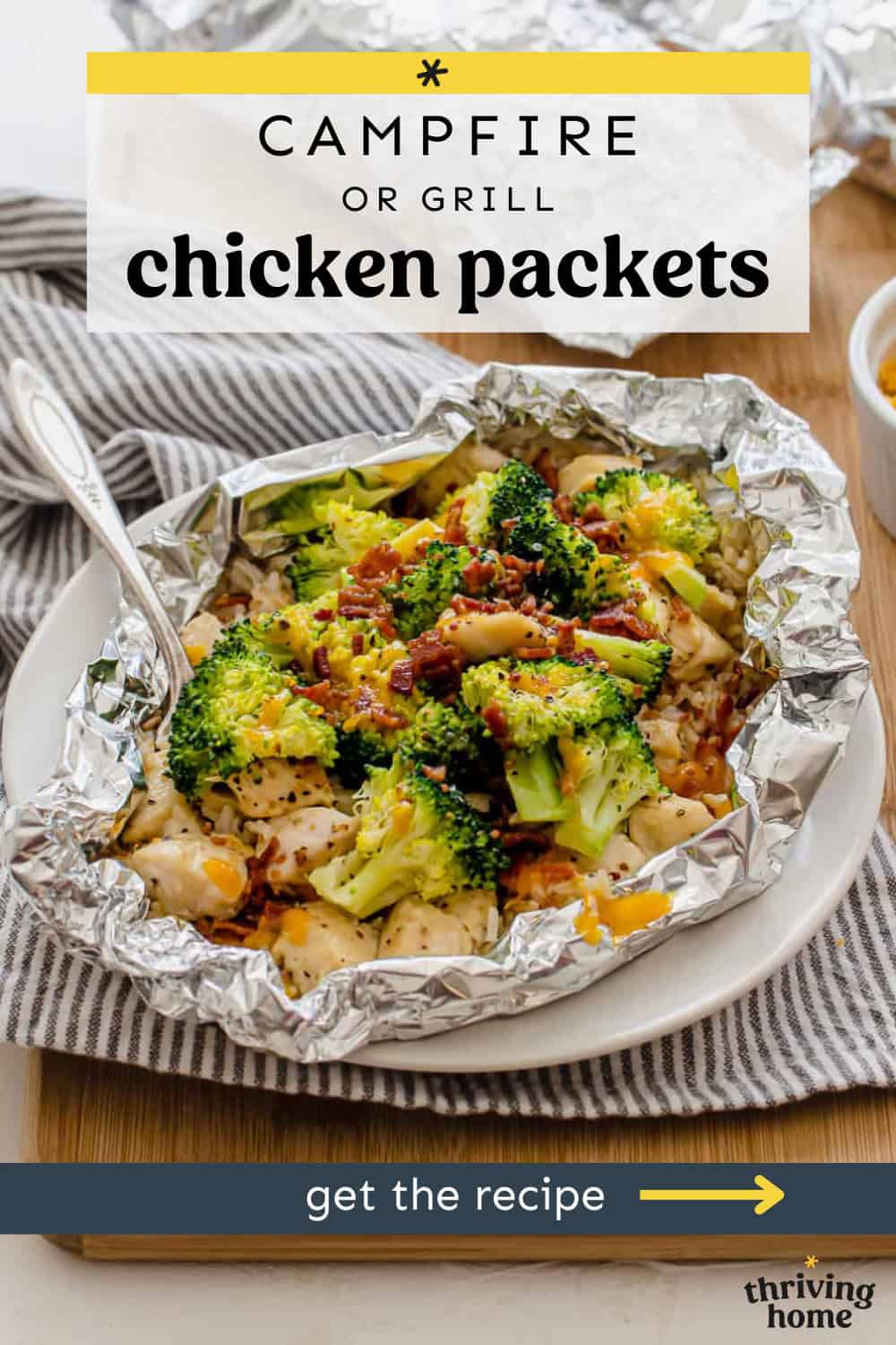 Broccoli, chicken, rice, cheese and bacon cooked in a foil packet that is open on a plate.