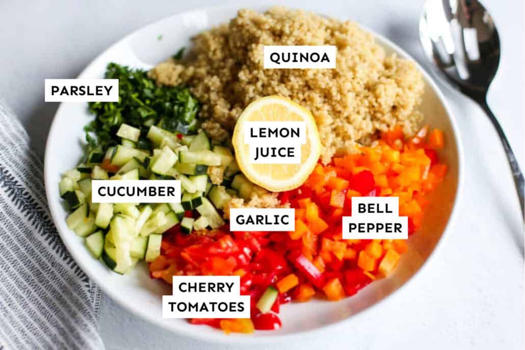 Ingredients for quinoa tabbouleh measured out in a bowl and labeled.