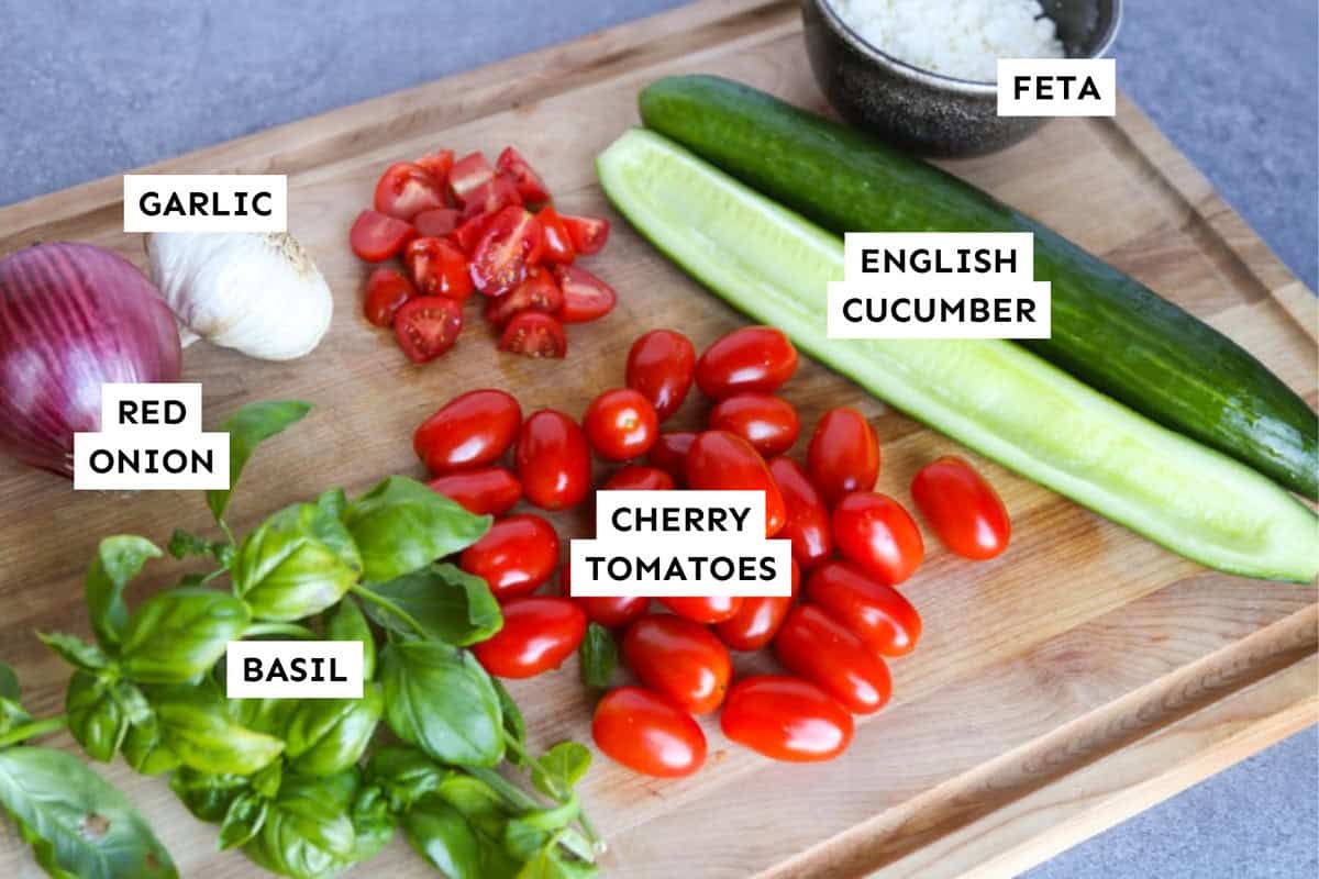 Cucumber tomato feta salad ingredients measured out and labeled.