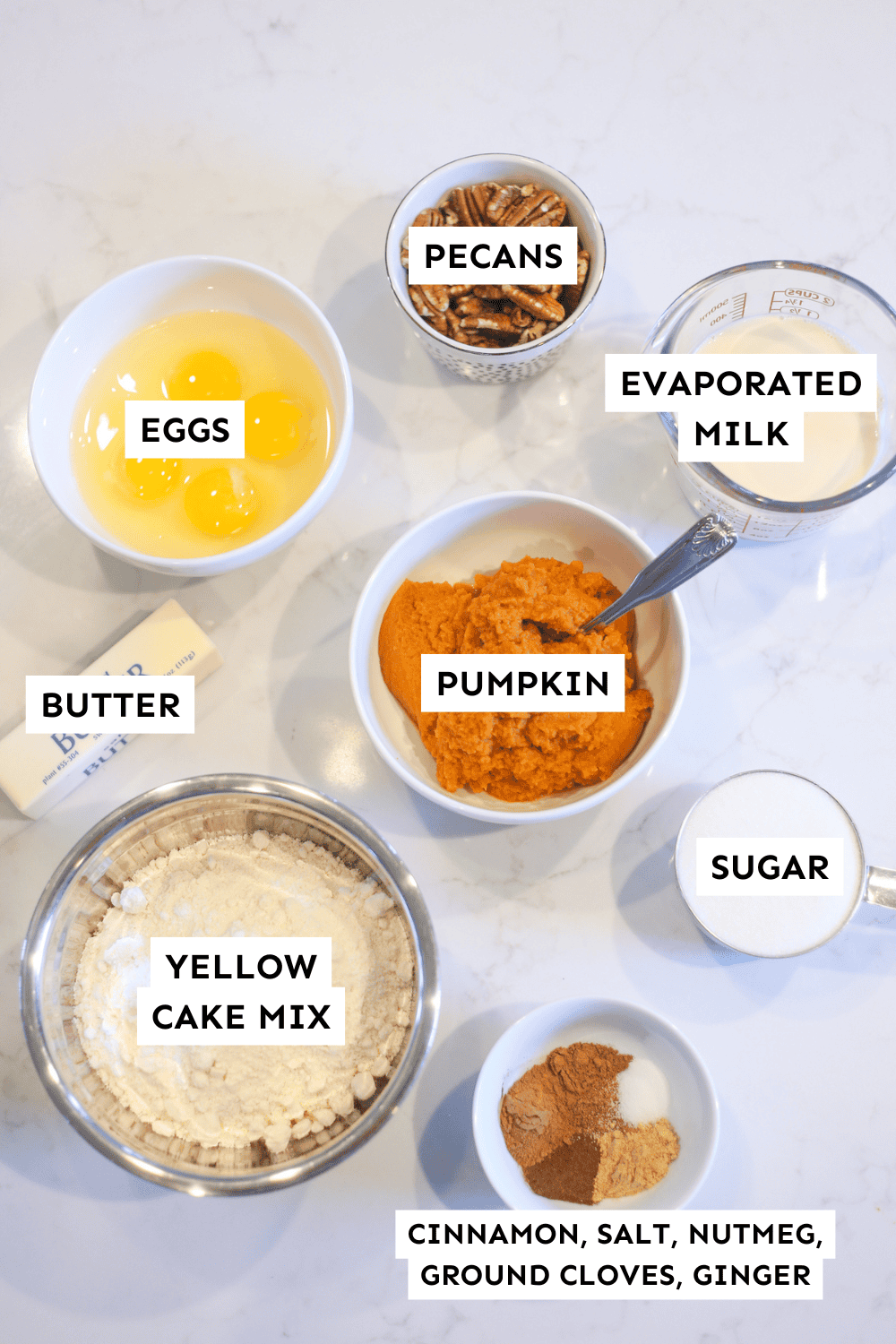 Pumpkin dump cake ingredients measured out and labeled.