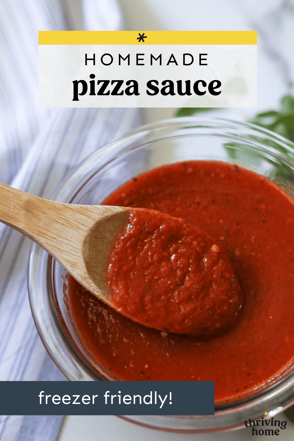 A bowl of homemade pizza sauce with a wooden spoon dipped in it. 