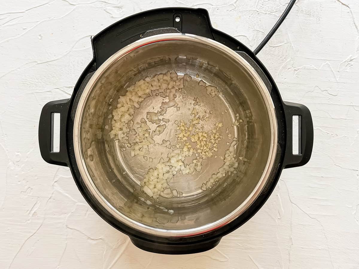 Onions and minced garlic sauteeing in the Instant Pot.