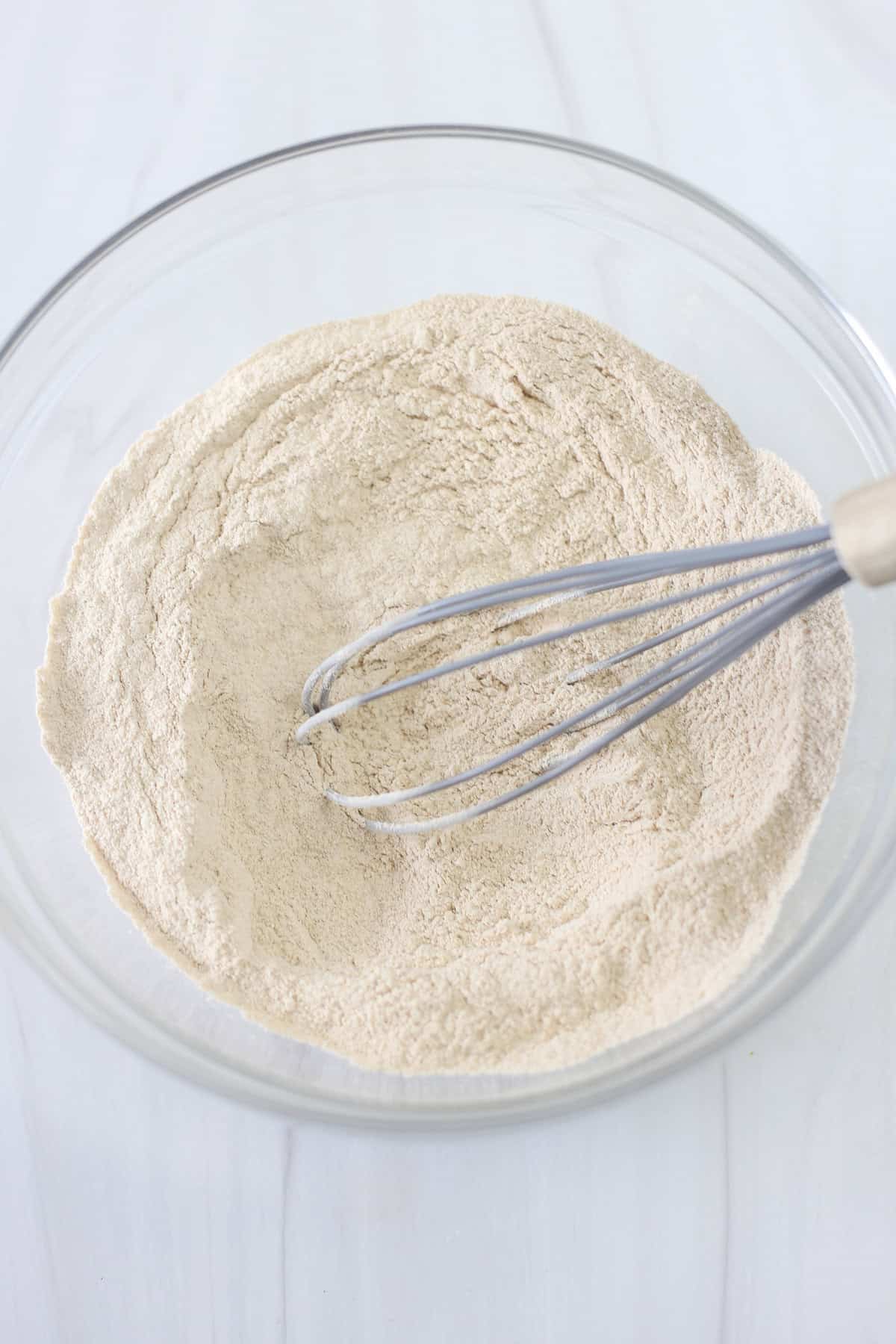 Dry ingredients for banana breakfast cake being whisked together.