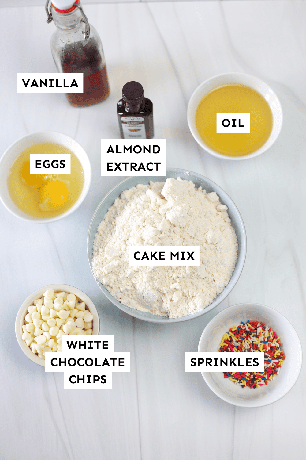 Funfetti cake mix cookie ingredients measured out and labeled.