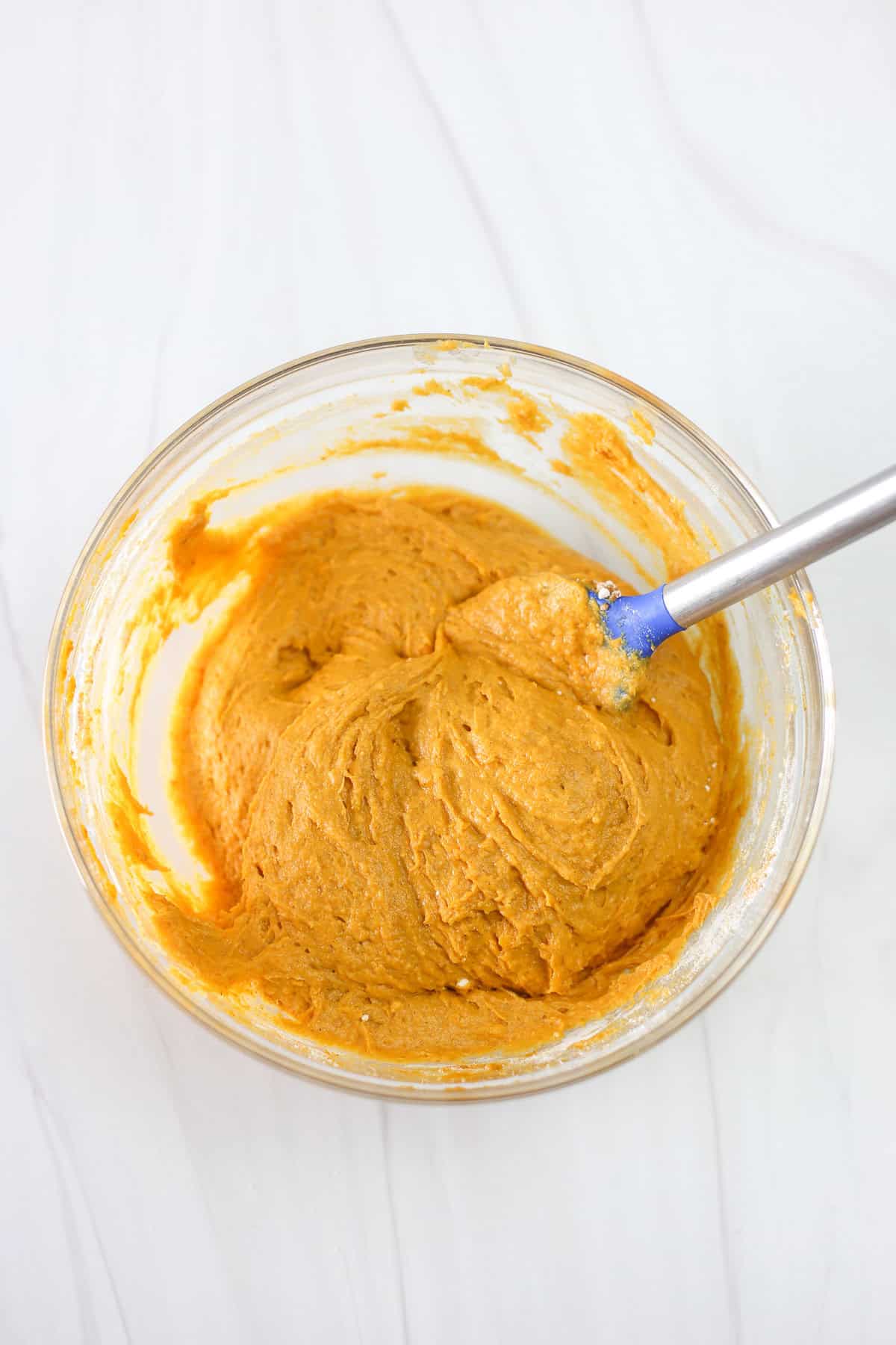 Pumpkin spice cake mix cookie batter in a mixing bowl.