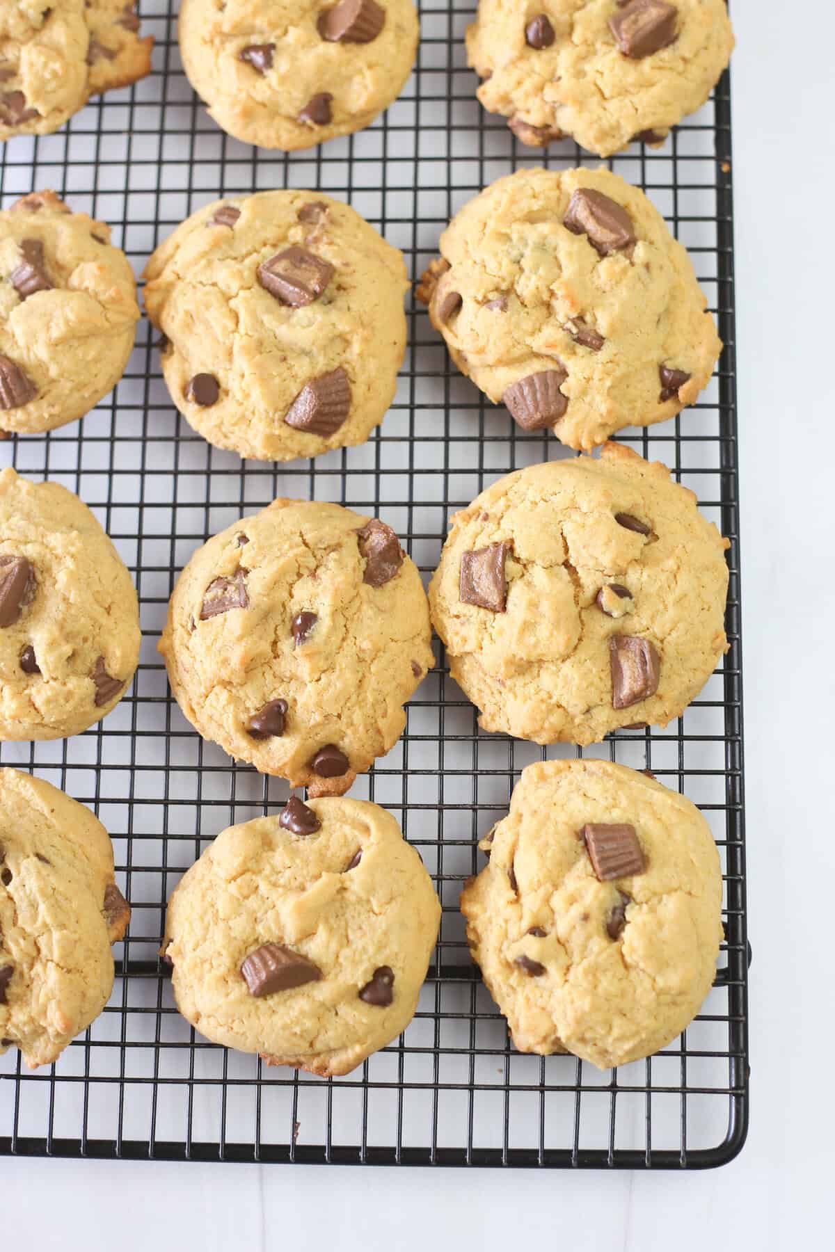 Reese's peanut butter cup cake mix cookies cooling on a baking rack.