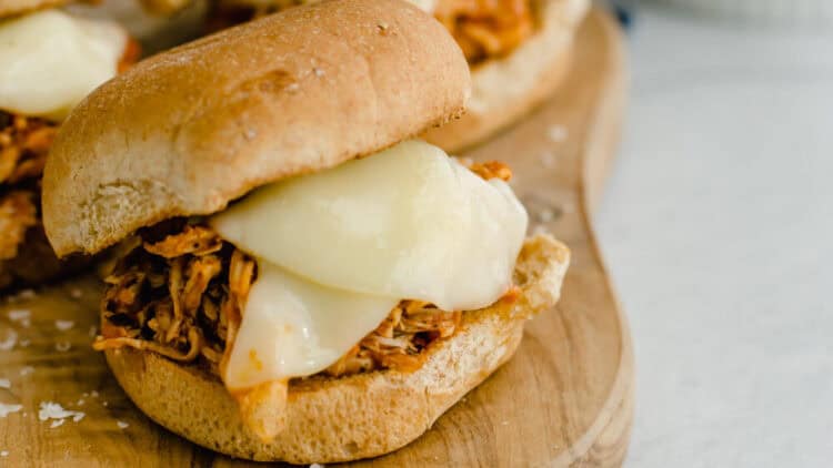 Chicken parmesan sliders on a cutting board.