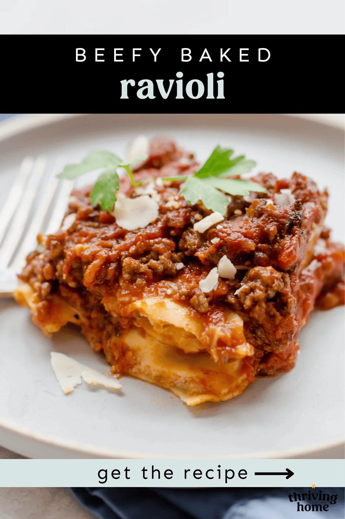 A serving of beefy baked ravioli on a plate with fresh parsley on top.