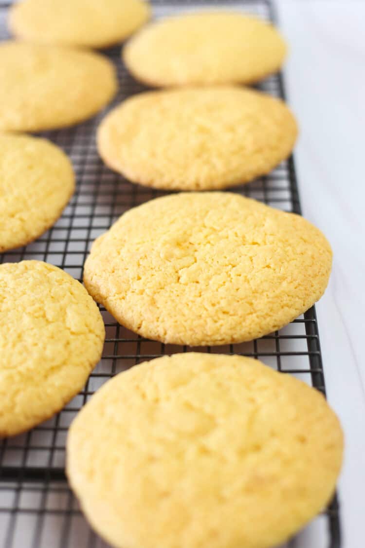 Cake mix cookies lined up on a cooling rack.