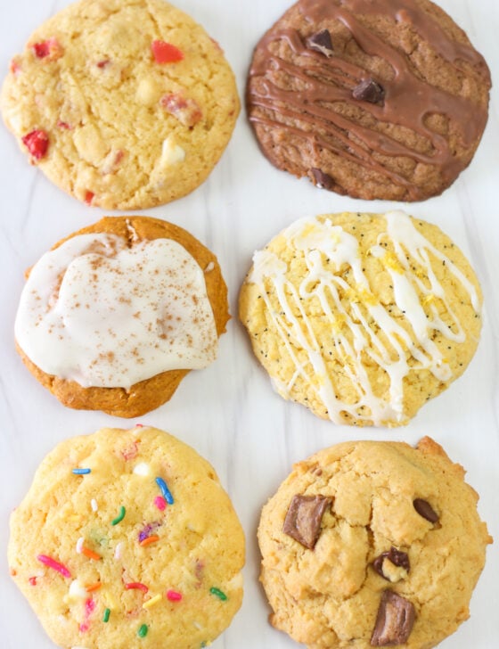 One each of six different cake mix cookie flavors lined up: strawberries and cream, Nutella, pumpkin spice, lemon poppyseed, Funfetti, and peanut butter cup.