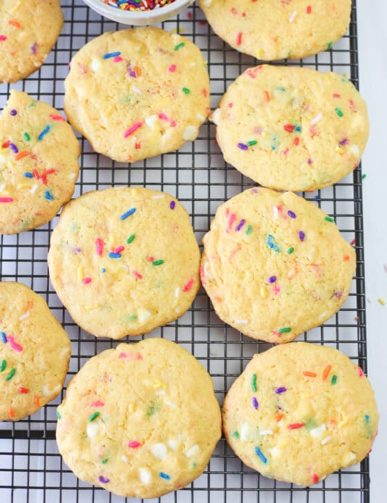 Funfetti cake mix cookies cooling on a baking rack.