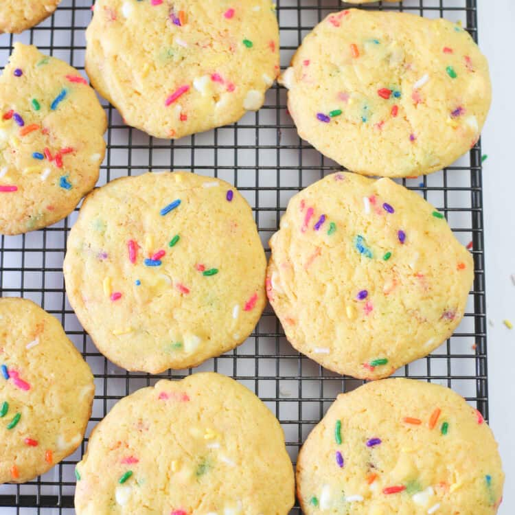 Funfetti cake mix cookies cooling on a baking rack.