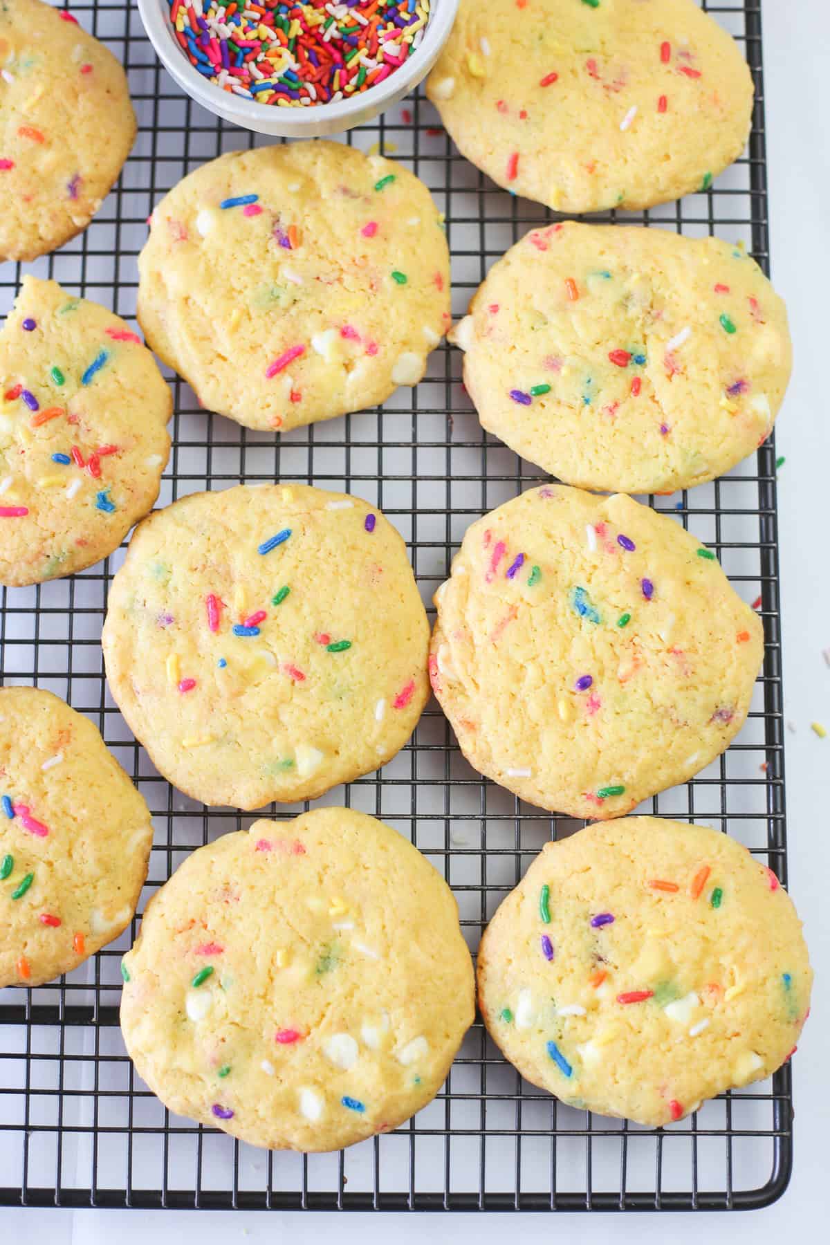 Funfetti cake mix cookies cooling on a baking rack.