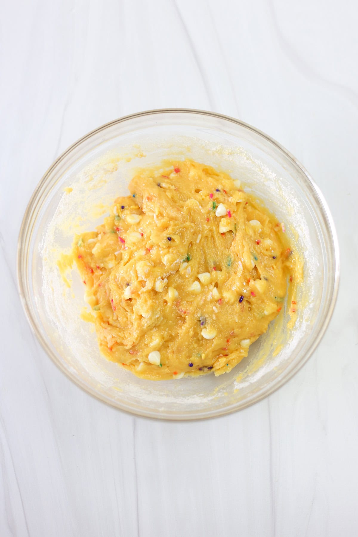 Funfetti cake mix cookie dough in a mixing bowl.