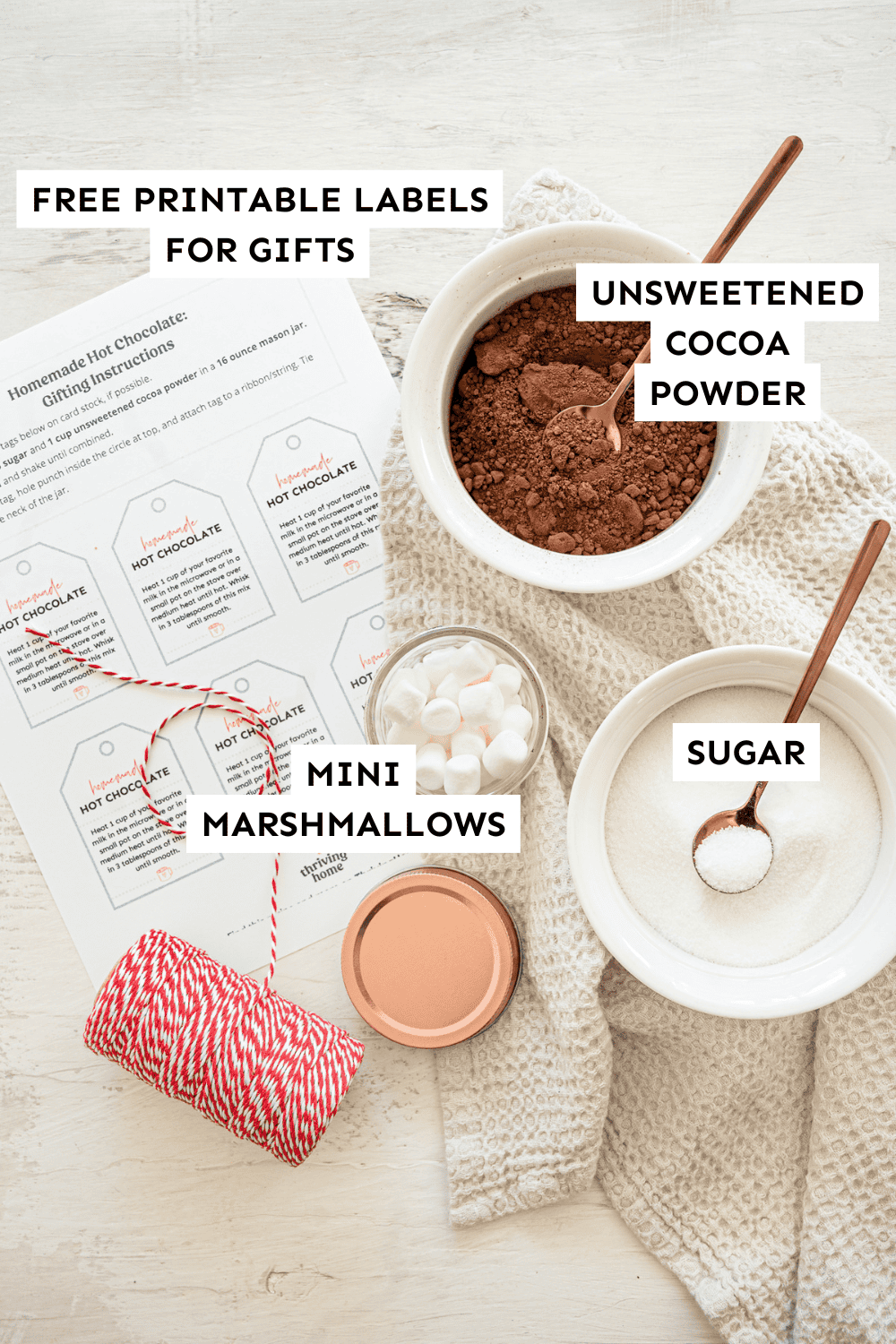 Homemade hot chocolate ingredients laid out with printable labels to make gifts.