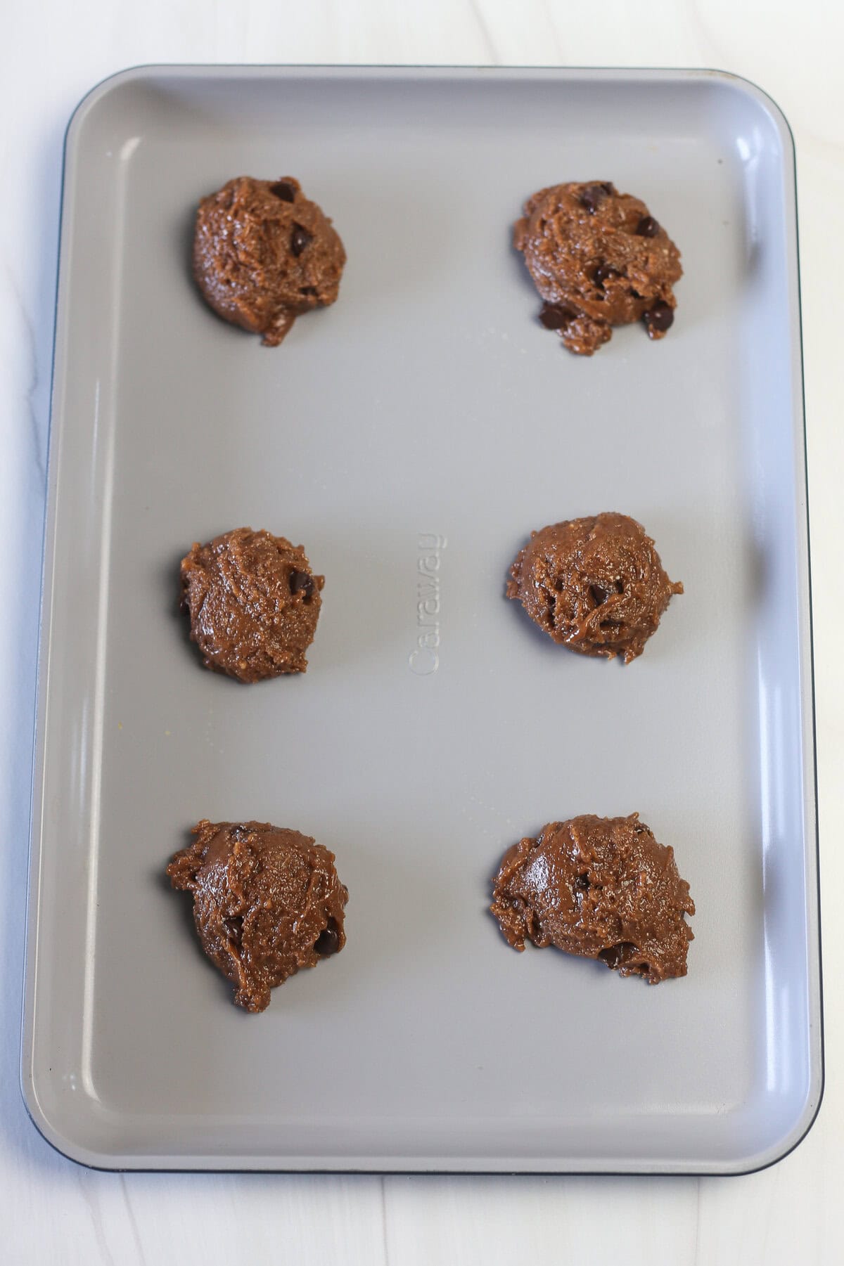 Nutella cake mix cookie dough in balls on a baking pan ready for the oven.