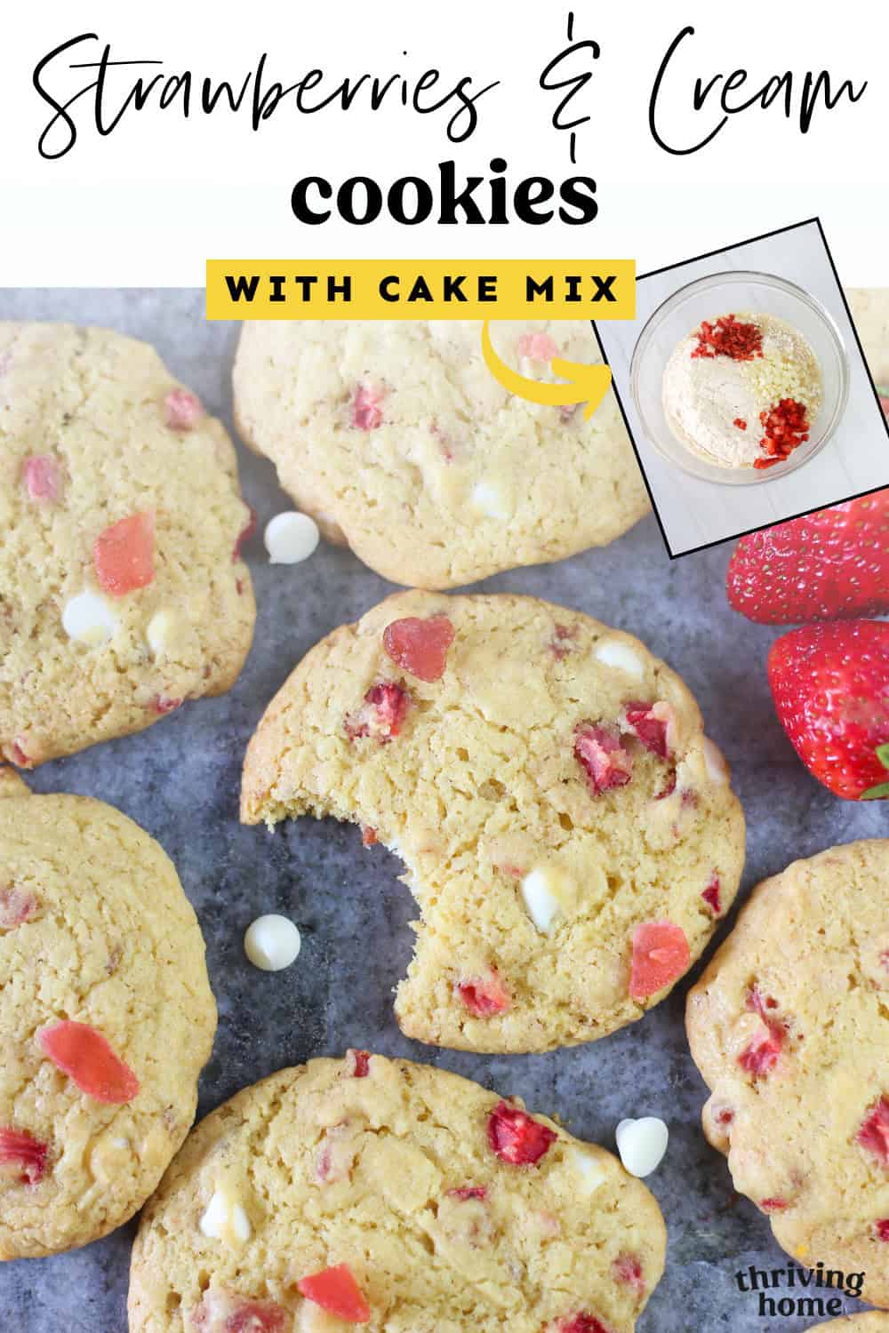 Strawberries and cream cake mix cookies lined up on gray marble with a bite out of one in the middle and an inset photo of ingredients in a mixing bowl.