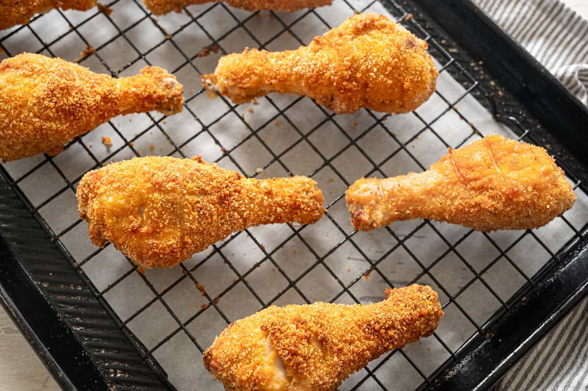 Crispy drumsticks on a baking pan straight from the oven.