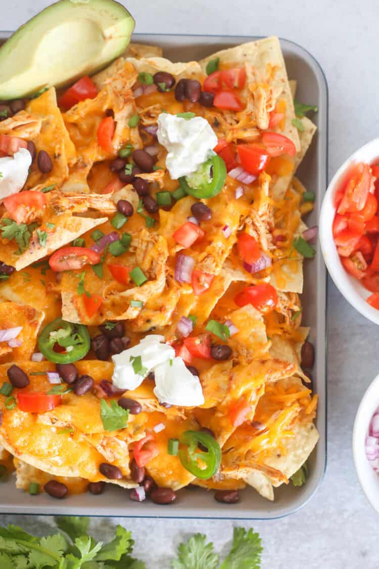 Shredded chicken nachos with toppings.