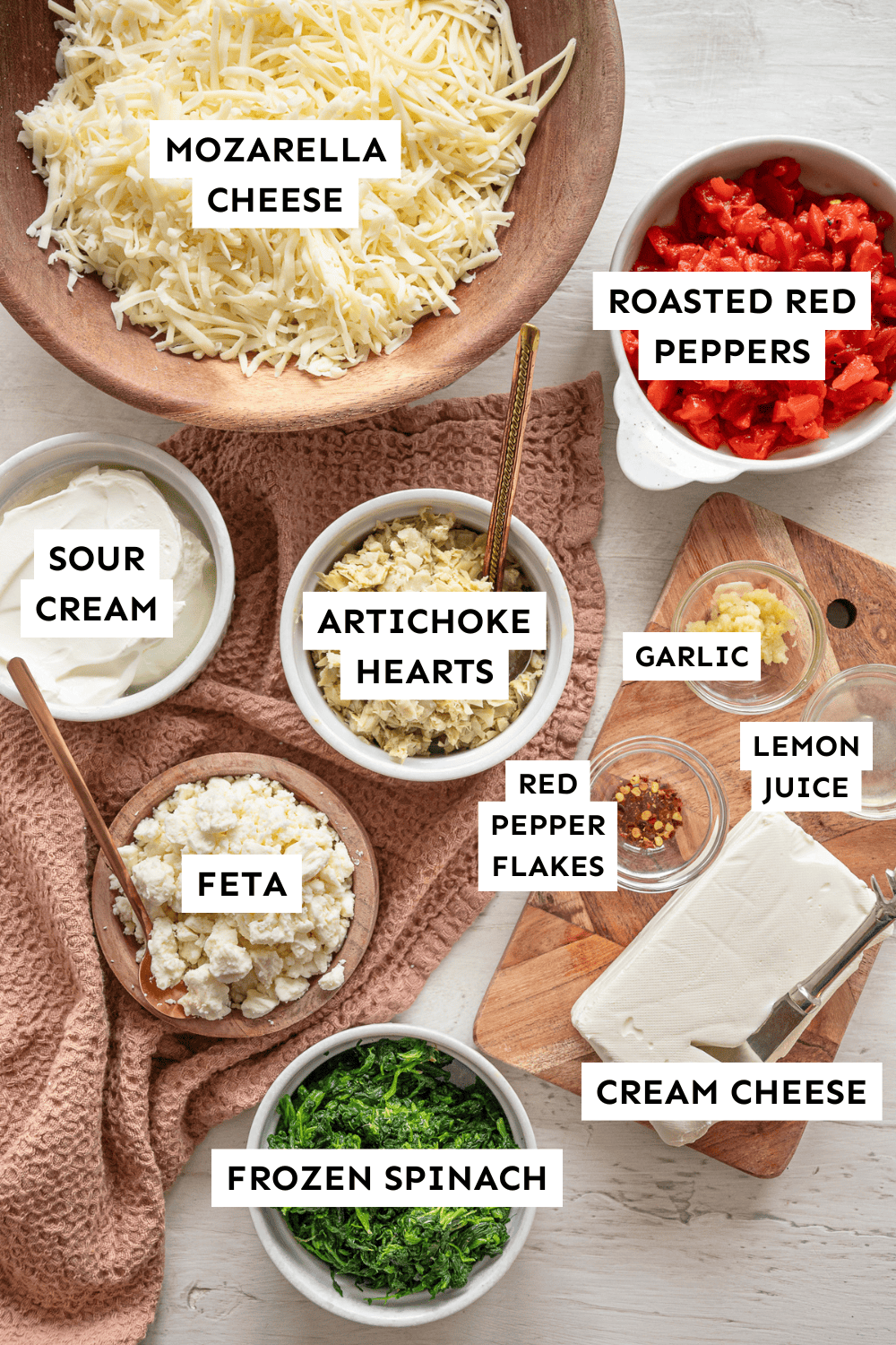 Ingredients for spinach artichoke dip measured out and labeled.