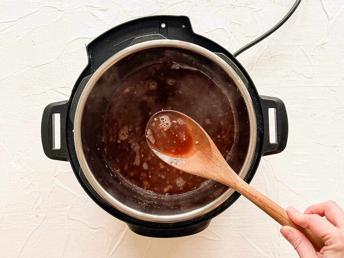 Beef broth in an Instant Pot with sauteed onions.