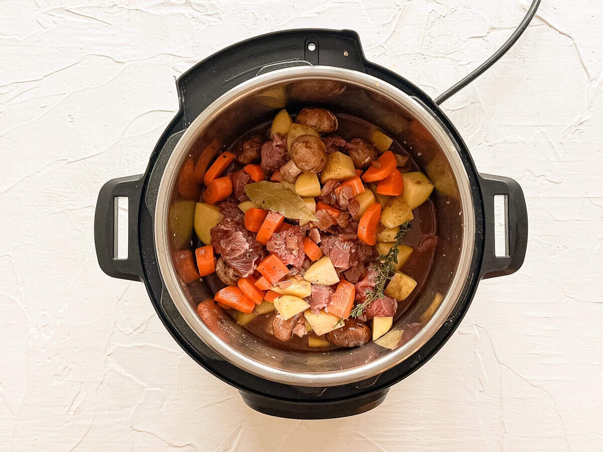 Raw ingredients for beef bourguignon in an Instant Pot ready to cook.