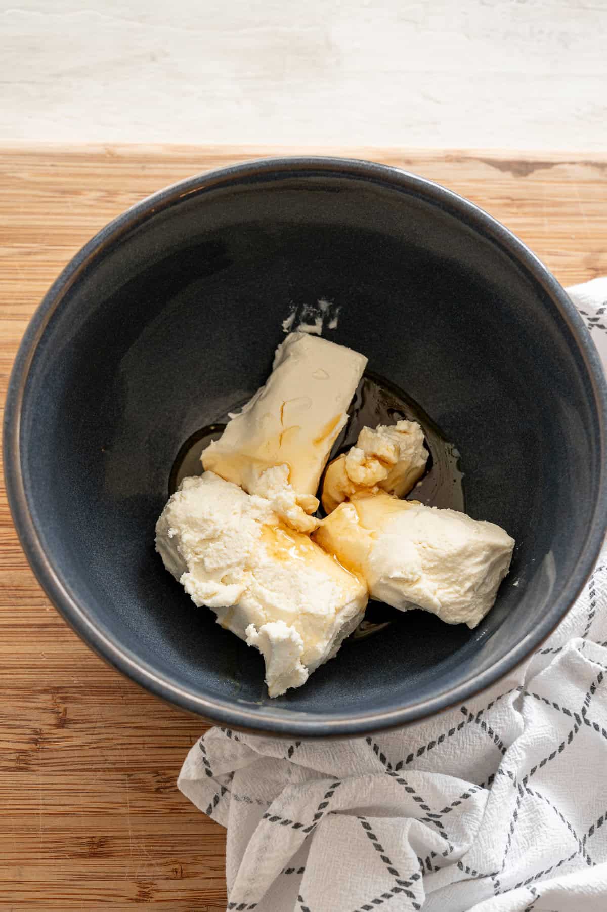 Cream cheese, goat cheese, and honey in a bowl ready to be whipped.