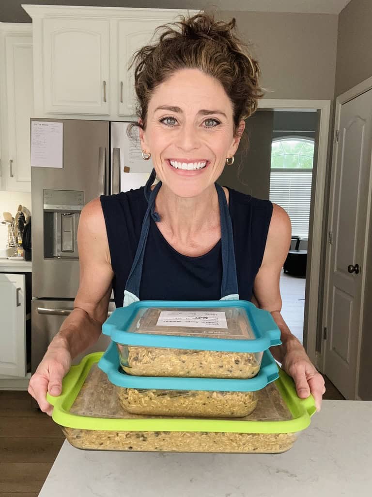 rachel holding several batches of baked oatmeal to go into the freezer.