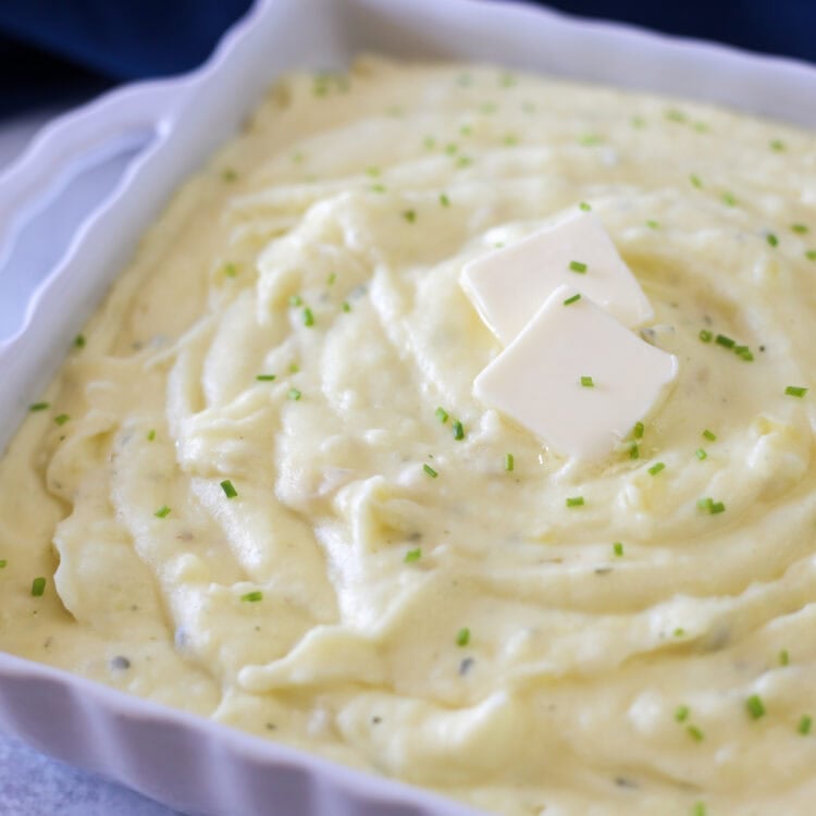 Gourmet Boursin mashed potatoes swirled in a white baking dish ready to serve.