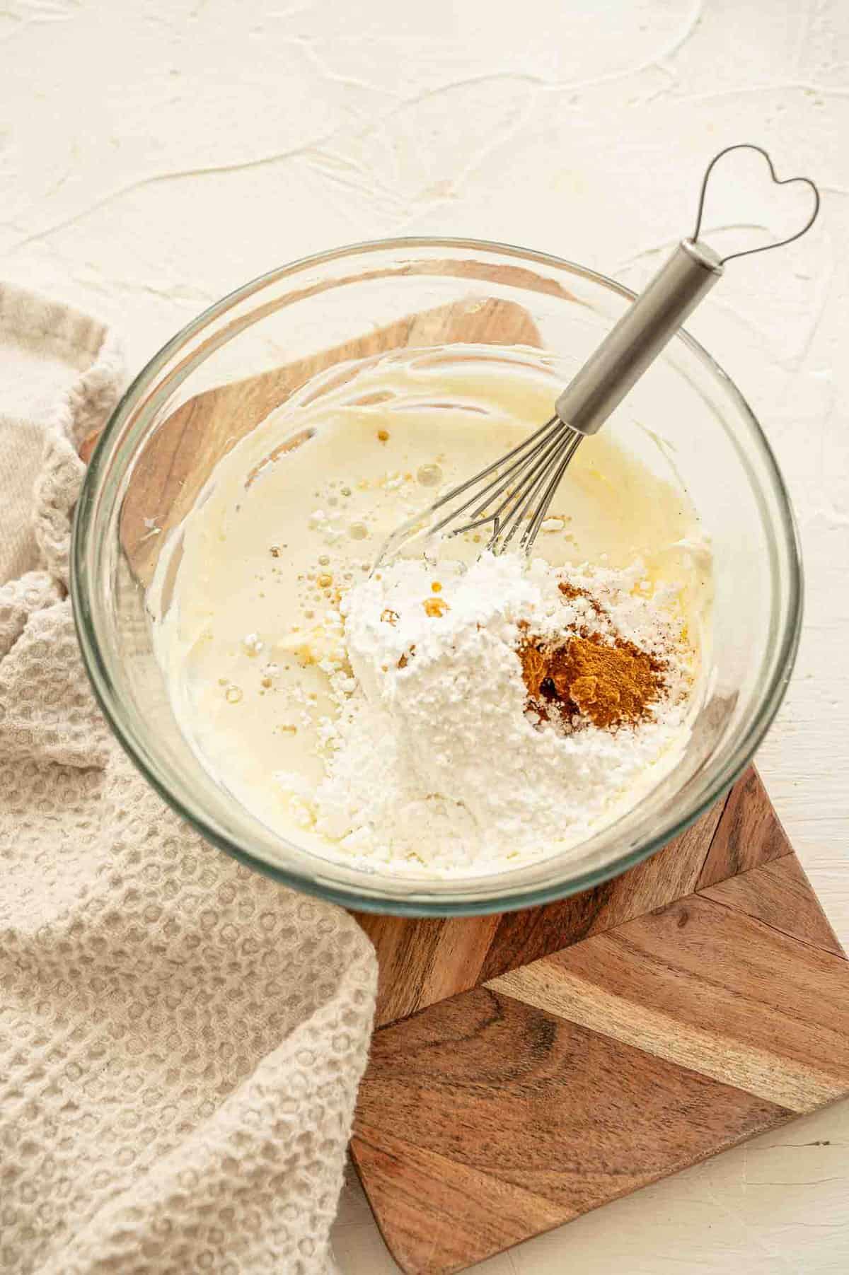 Ingredients for cream cheese icing all dumped in a bowl ready to be mixed.