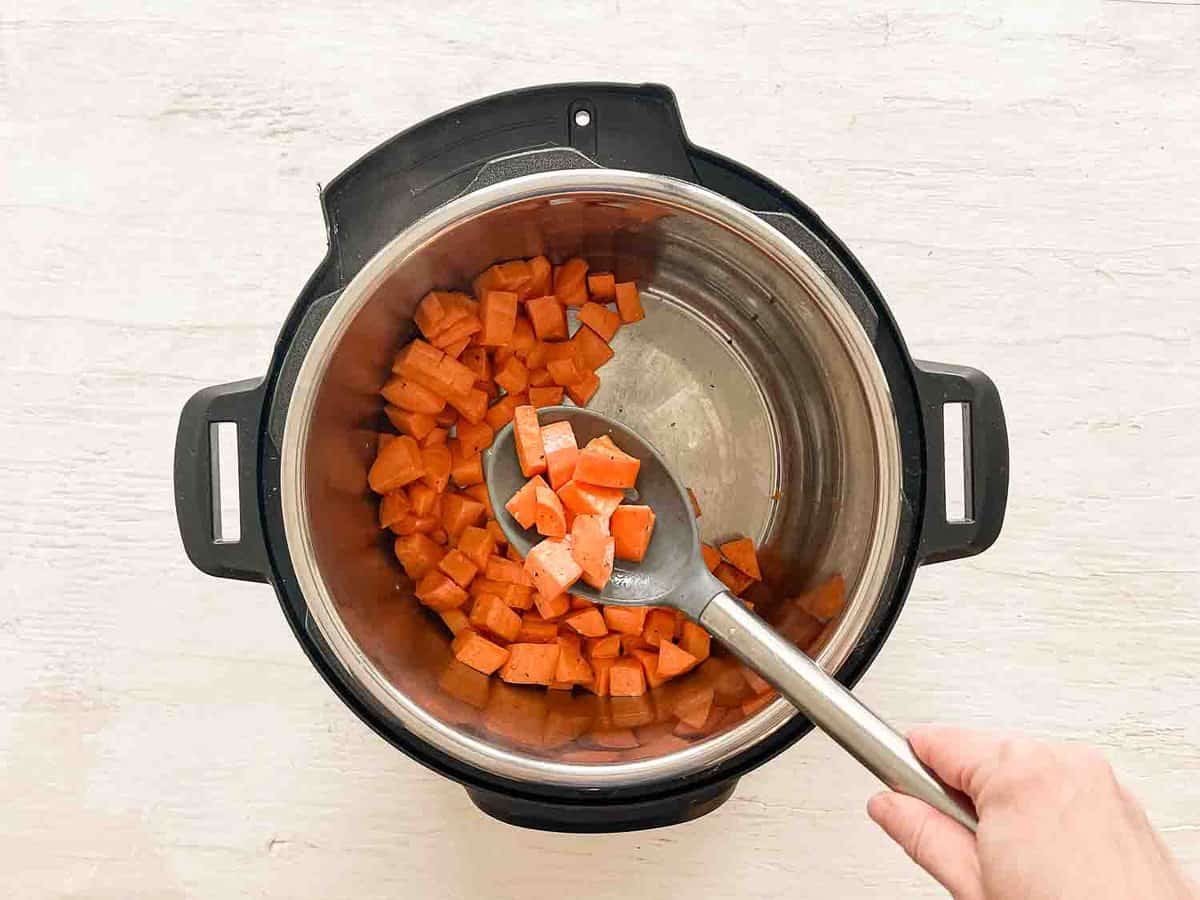 Sweet potato cubes being sauteed in an Instant Pot.