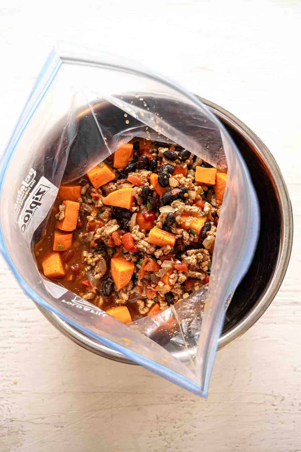 Turkey chili in a freezer-safe bag inside an Instant Pot bowl.