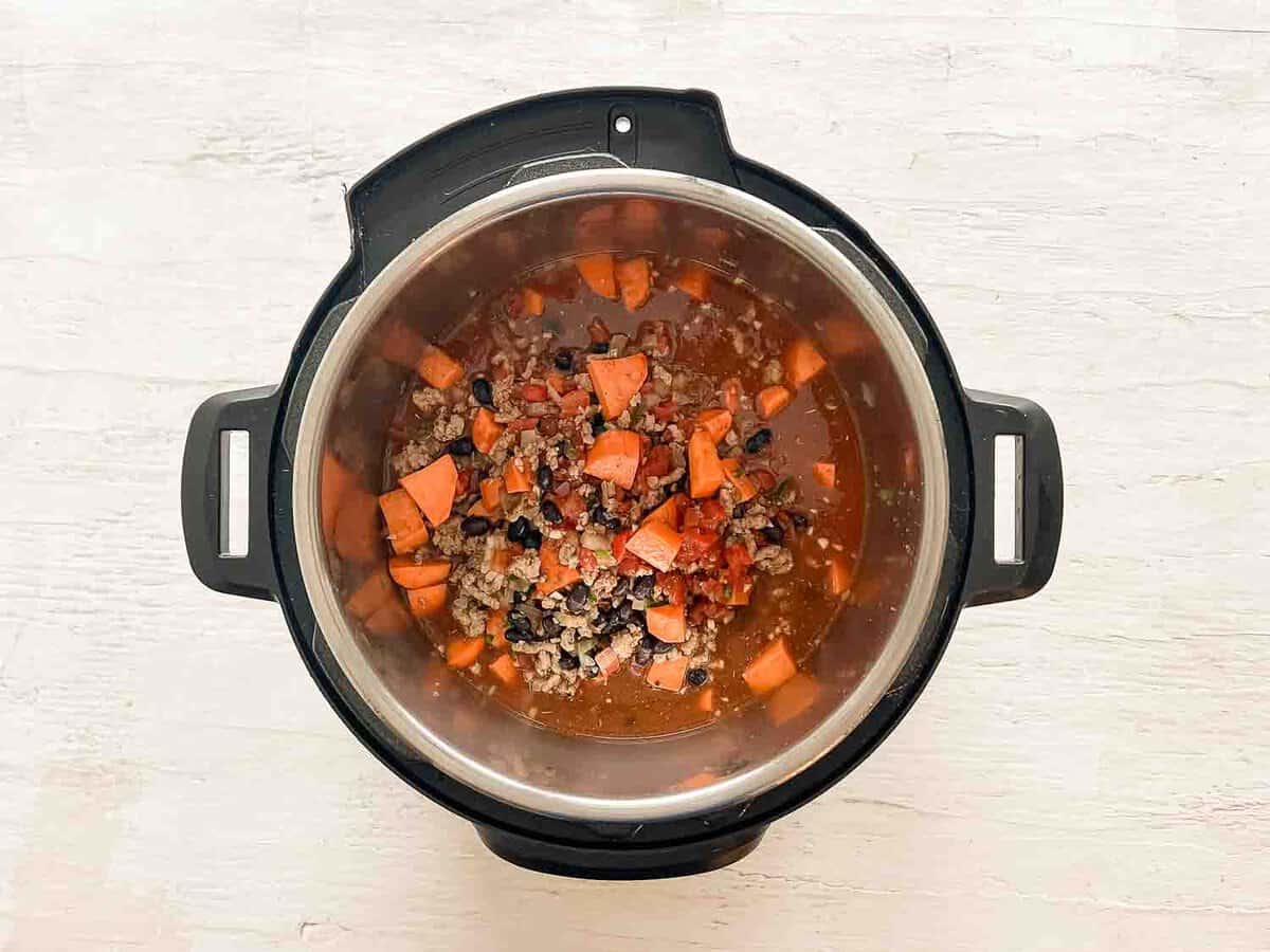 Ingredients for turkey chili dumped in an Instant Pot.