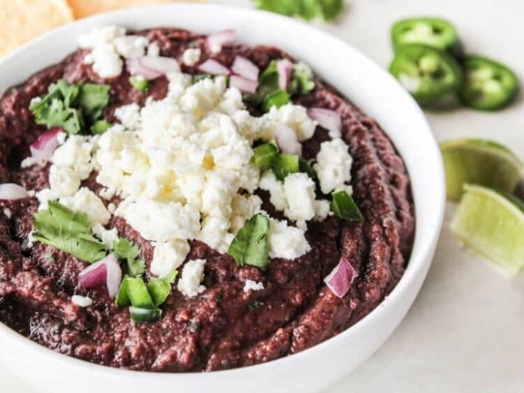 Quick and easy black bean dip in a bowl with feta on top.