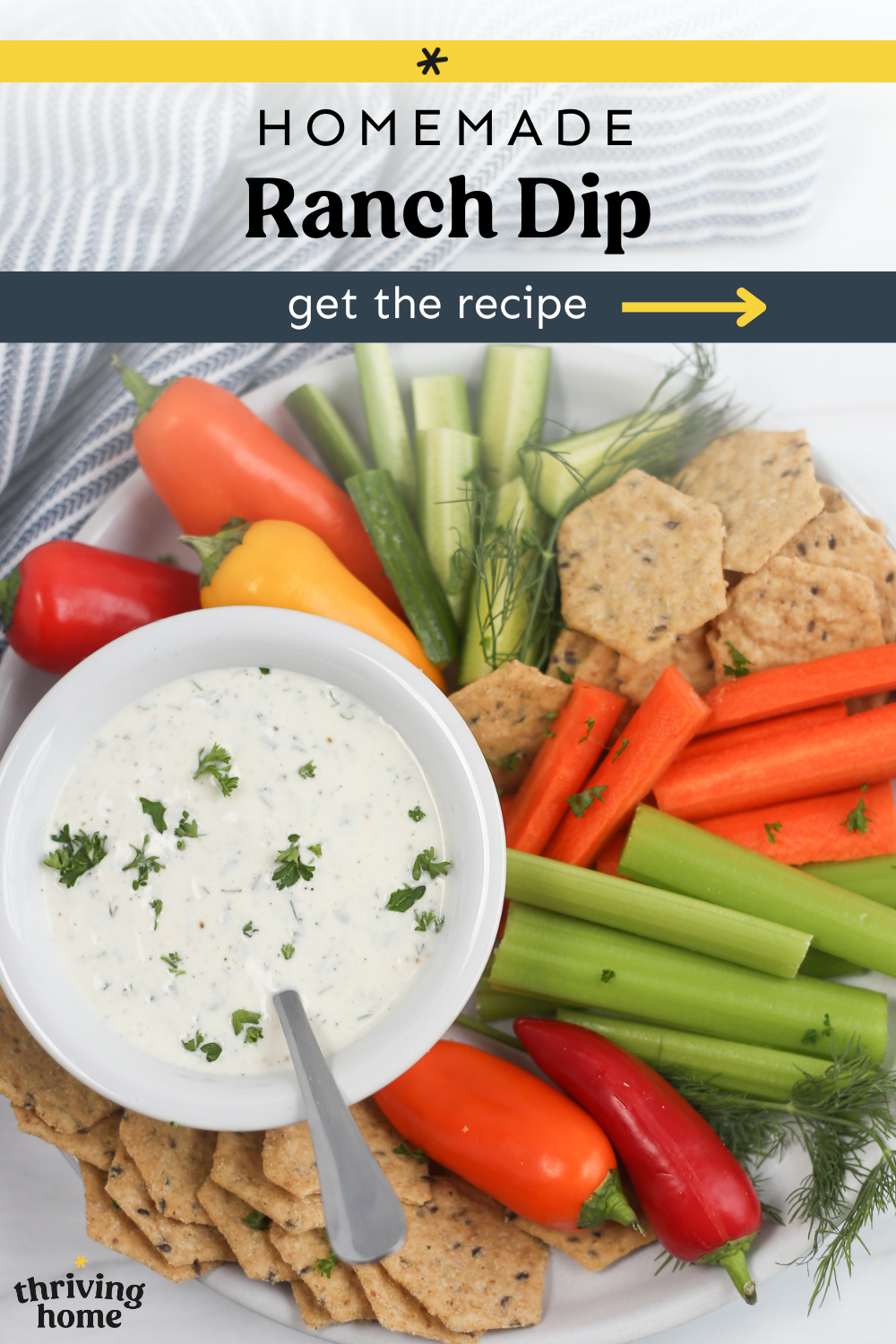 Veggie sticks and crackers om a platter with a bowl of homemade ranch dip.