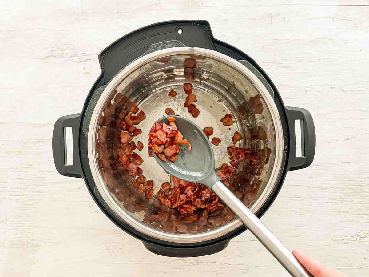 Bacon pieces sauteing in an Instant Pot.