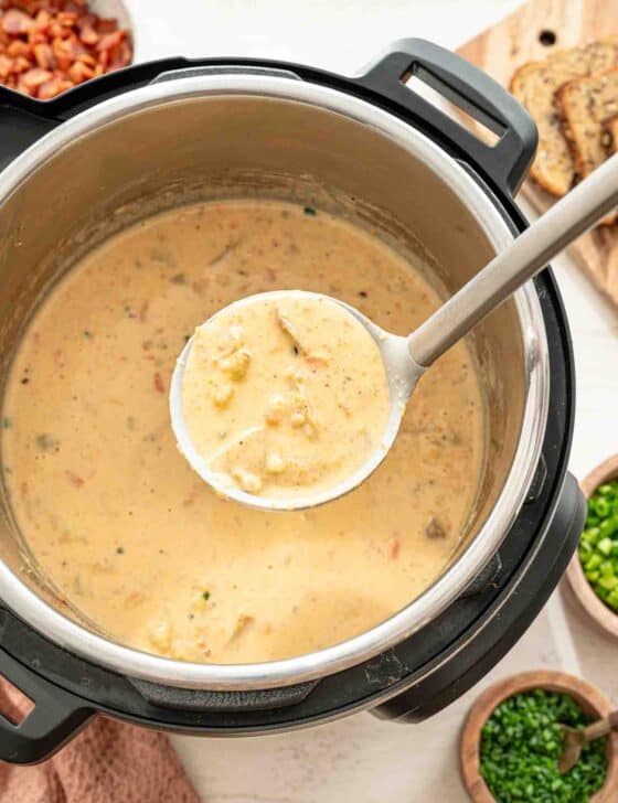 Cheddar and bacon potato soup being ladled out of an Instant Pot.