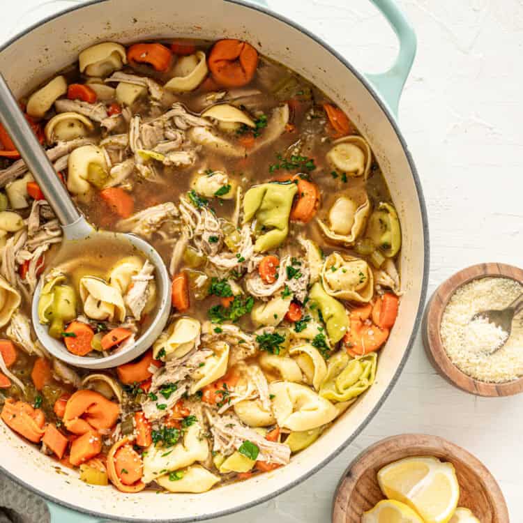 A large pot of chicken tortellini soup ready to serve.