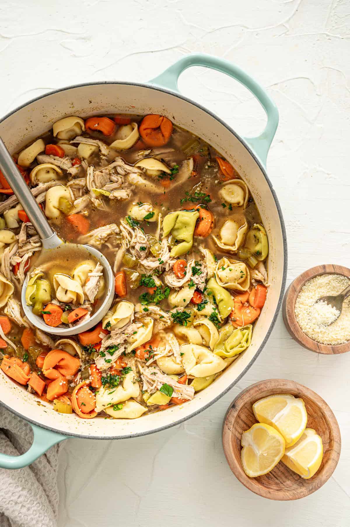 A large pot of chicken tortellini soup ready to serve.