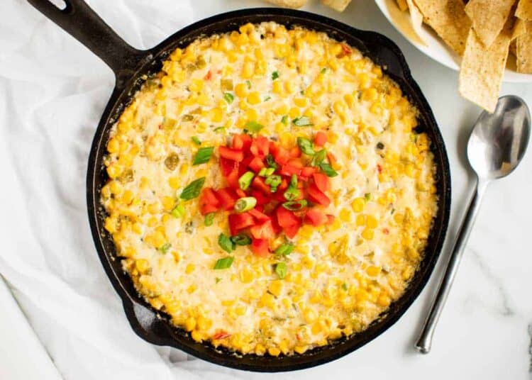 Hot corn dip in a cast iron skillet.