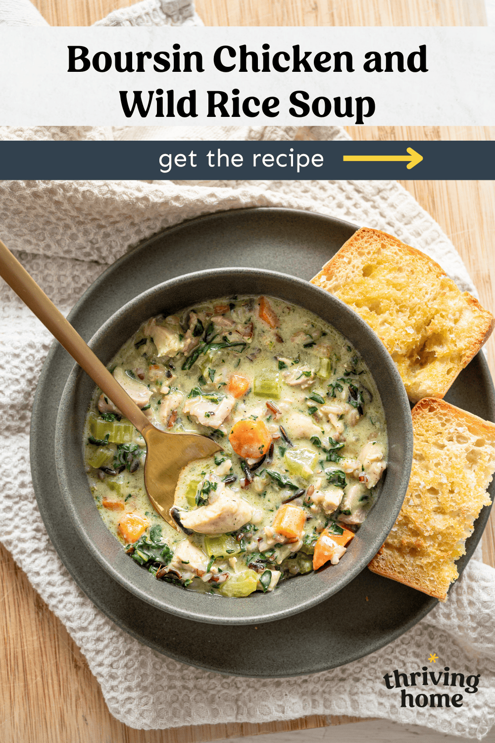 Boursin Chicken and Wild Rice Soup in a bowl with crusty bread.