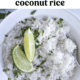 Instant Pot coconut rice in a bowl with chopped cilantro and lime wedges on top.