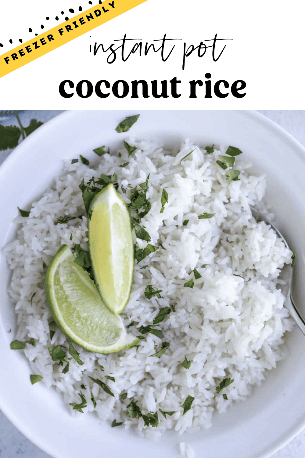 Instant Pot coconut rice in a bowl with chopped cilantro and lime wedges on top.