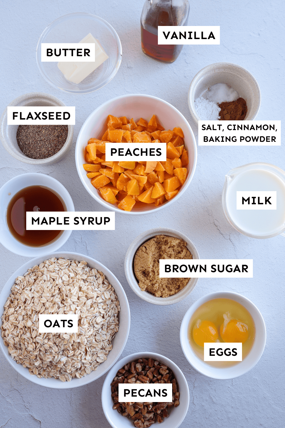 Ingredients for peach baked oatmeal measured out and labeled.