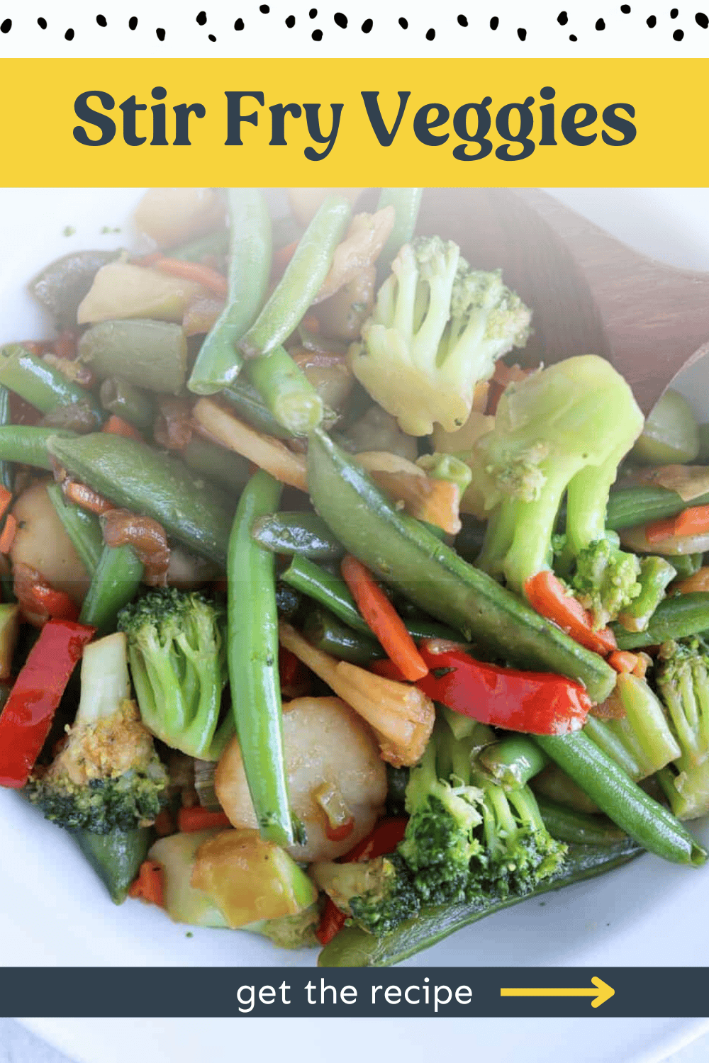 Stir fry veggies in a bowl with a wooden spoon.