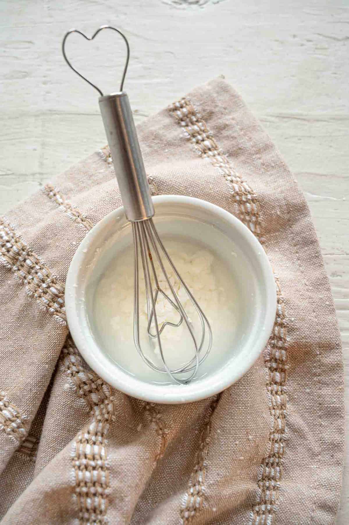 A small bowl with water and cornstarch making a slurry.